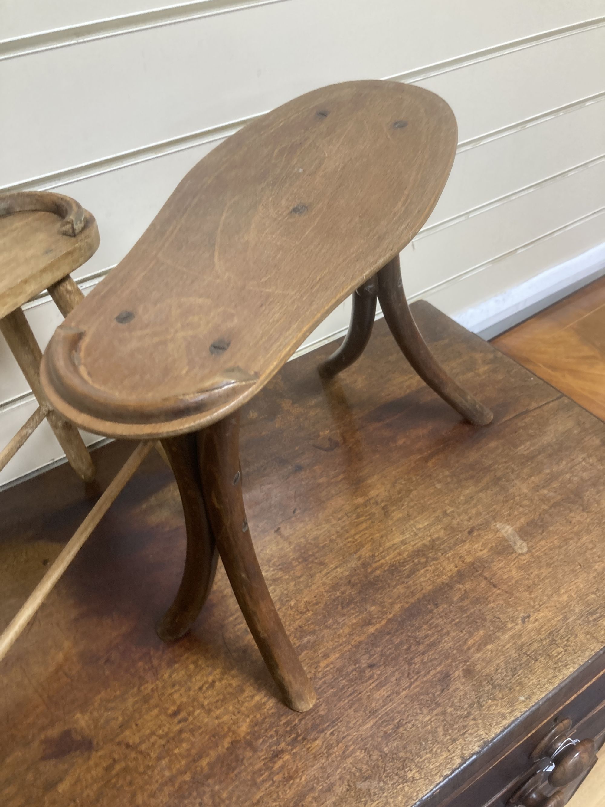 Two early 20th century treen shoe rests, larger 36cm wide, 35cm high